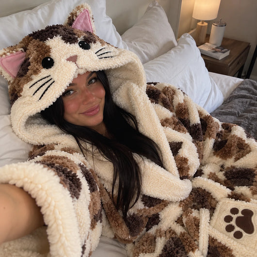 Selfie in bed wearing the heated CatRobe with the cat-head hood up
